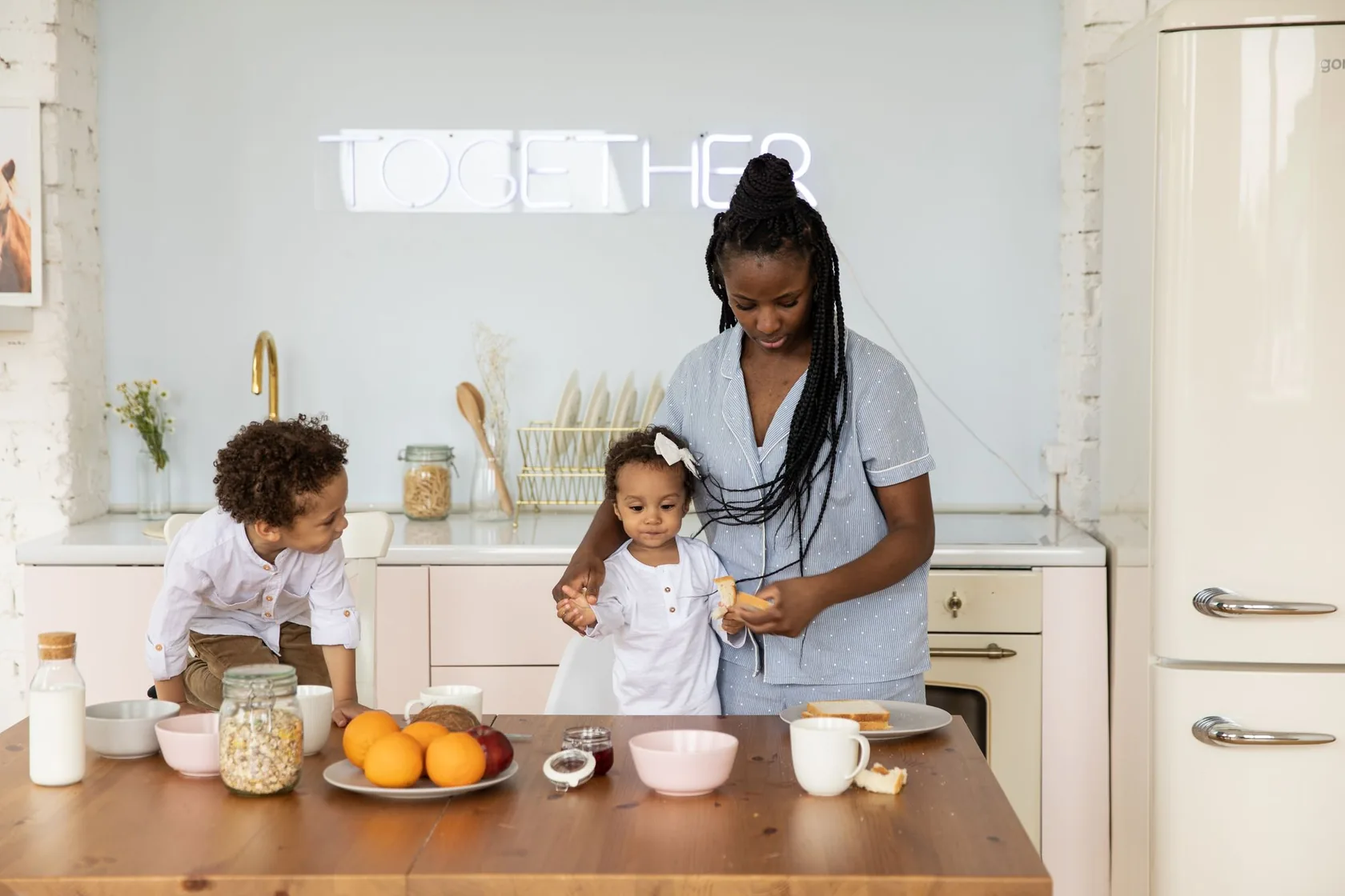 A mother and two children sharing breakfast at home
